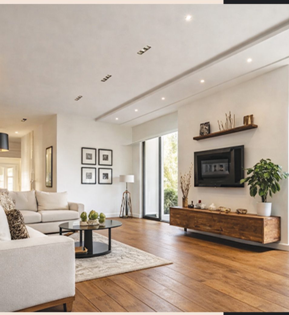 Open-plan living room with a cream sofa, oak floor and a floating walnut media console